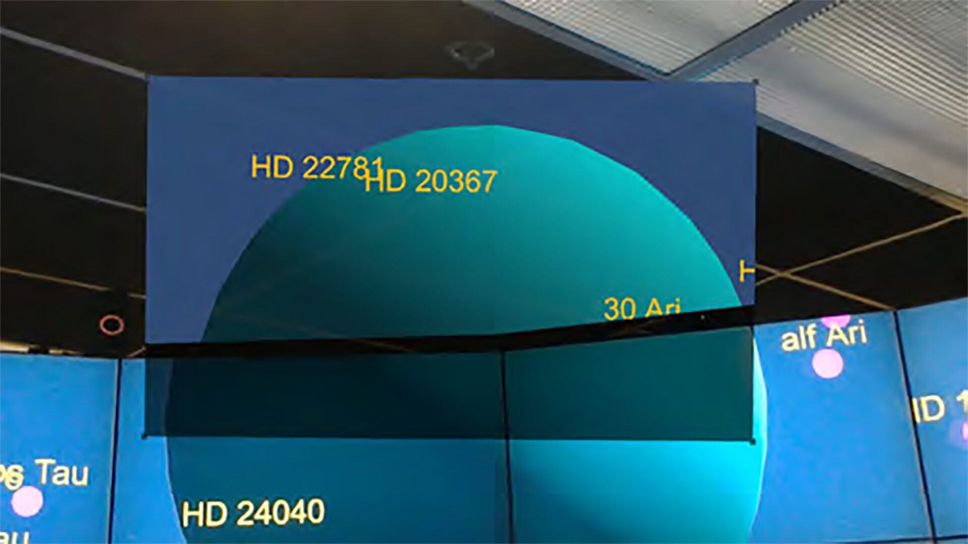 Extending Virtual Reality Display Wall Environments Using Augmented Reality