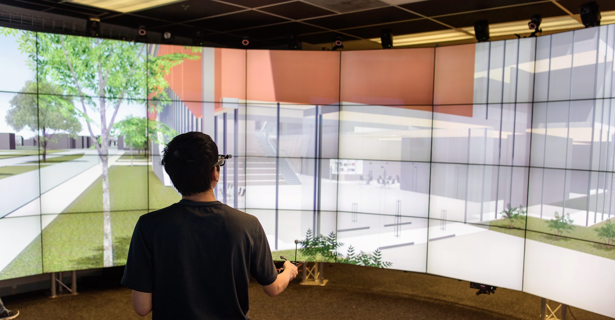 EVL PhD candidate Arthur Nishimoto navigates through the proposed virtual COE building in the CAVE2.