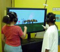Children using virtual ambients deployed on a plasma panel in their classroom.