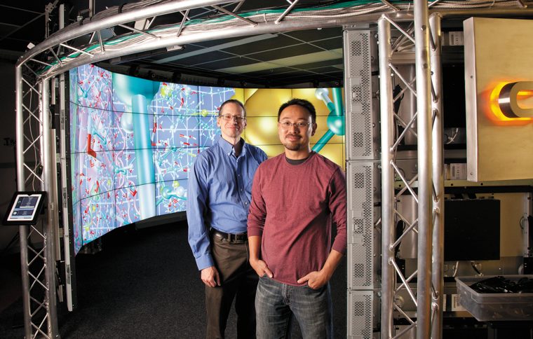 Andy Johnson (CS assoc. prof.) and  Jason Leigh (CS prof. &amp; EVL director) at the entrance to the CAVE2&trade; System.