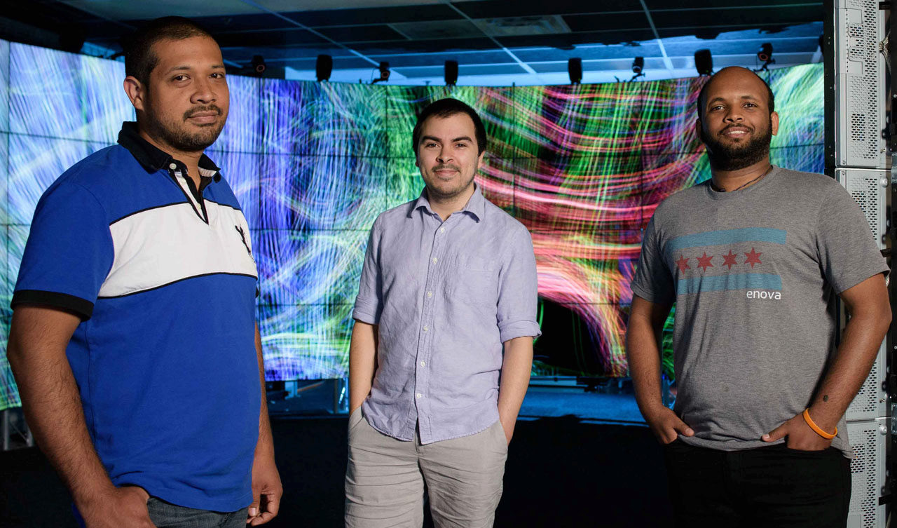 UIC Computer Science undergraduates (left to right) Carlos Uribe, Josh Rodriguez and Brook Habtegiorgis in the CAVE2&trade; Hybrid Reality Environment developed by the UIC Electronic Visualization Laboratory (EVL).